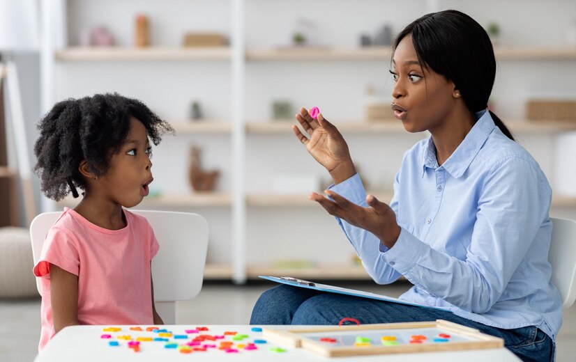 speech-therapist-working-with-little-black-girl_922936-45766